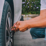 Low Section Of Man Inflating Car Tire